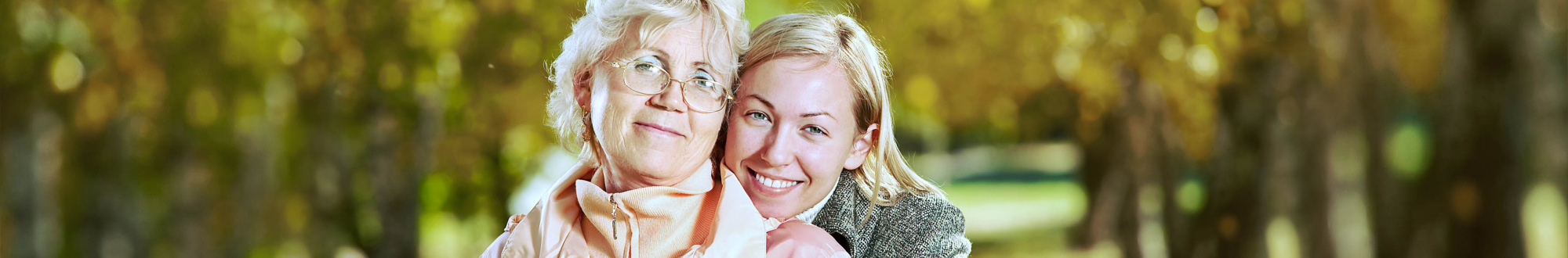 happy elder woman and her caregiver