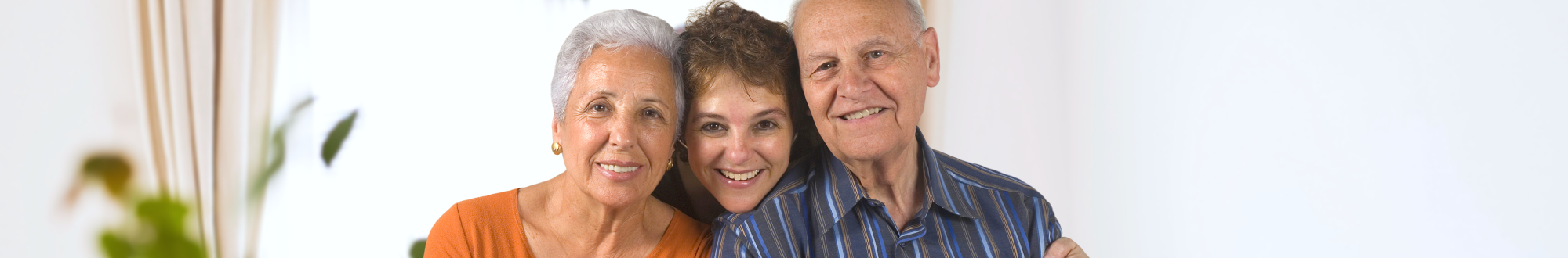 happy elderly couple with their daughter